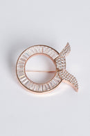 text -- rose gold brooch