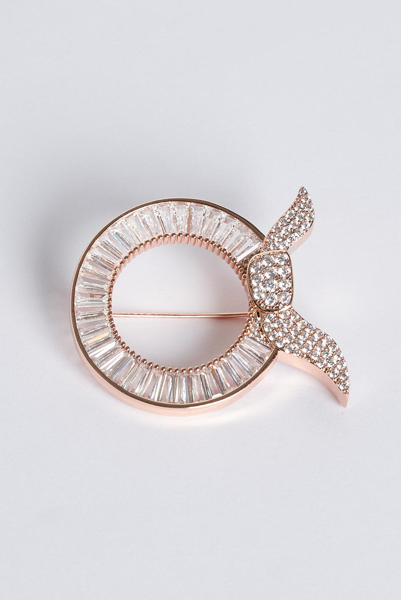 text -- rose gold brooch