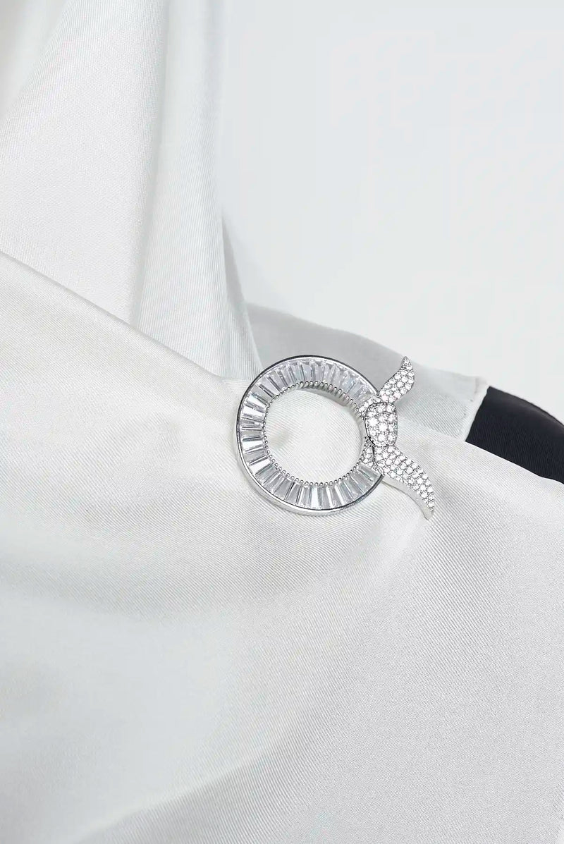 text -- silver brooch