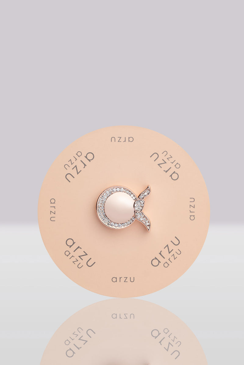text -- rose gold brooch