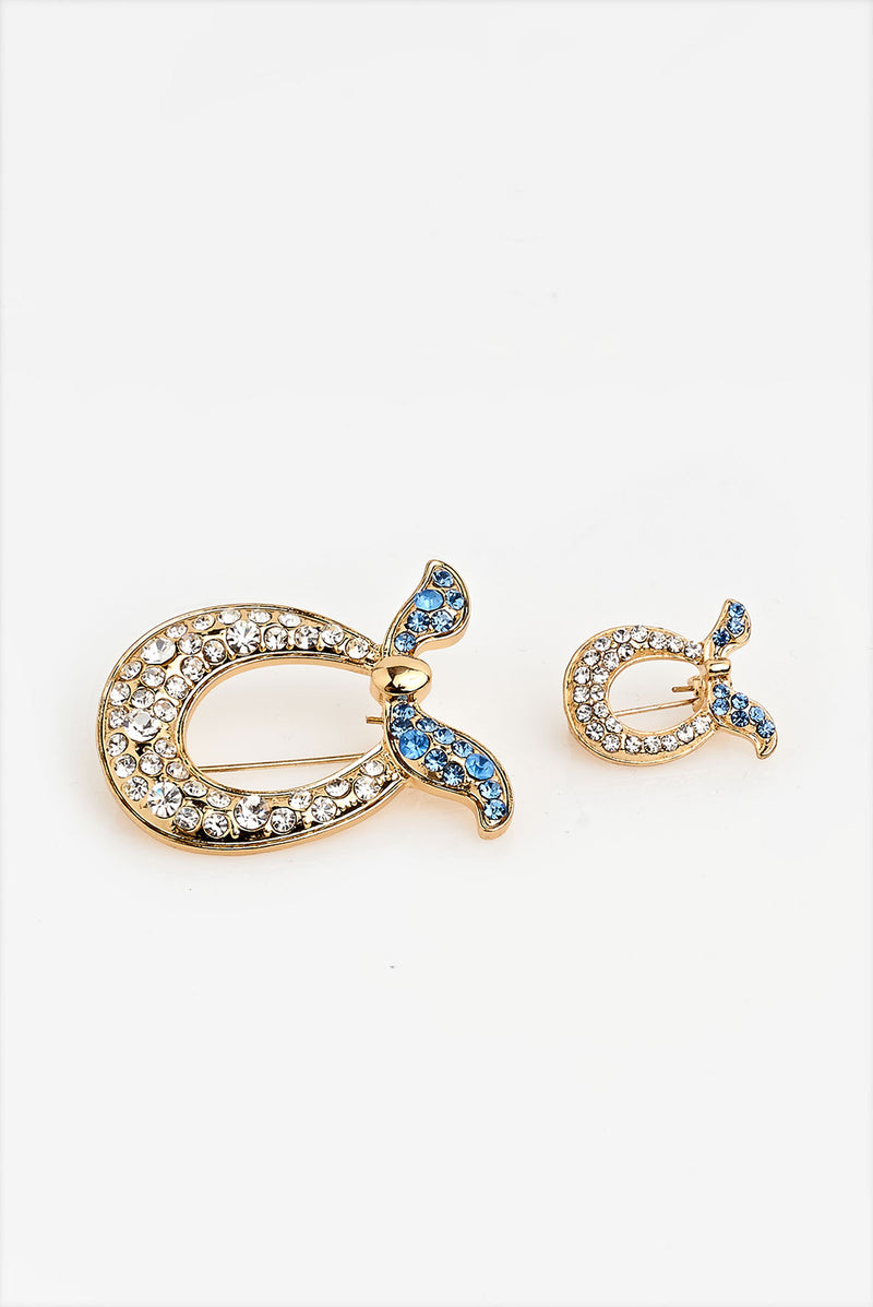 text -- brooch gold jet set blue