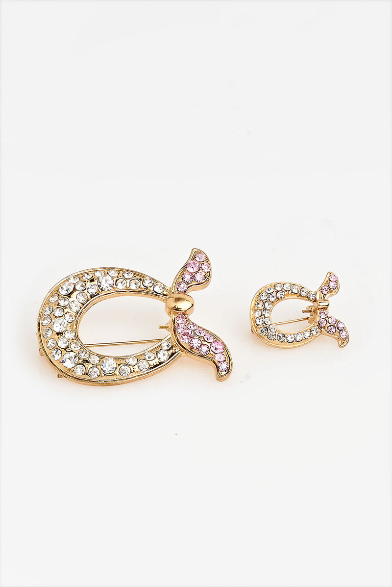 text -- brooch gold pink