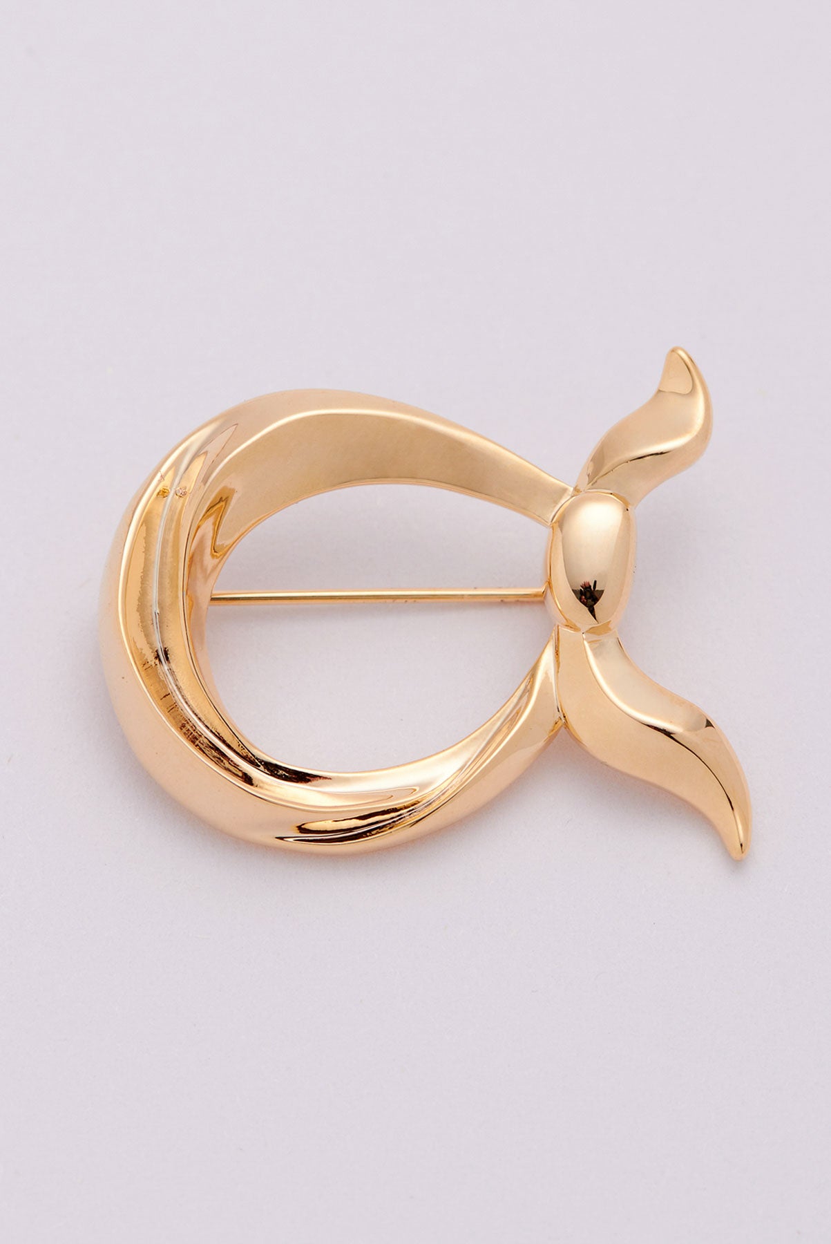text -- gold brooch