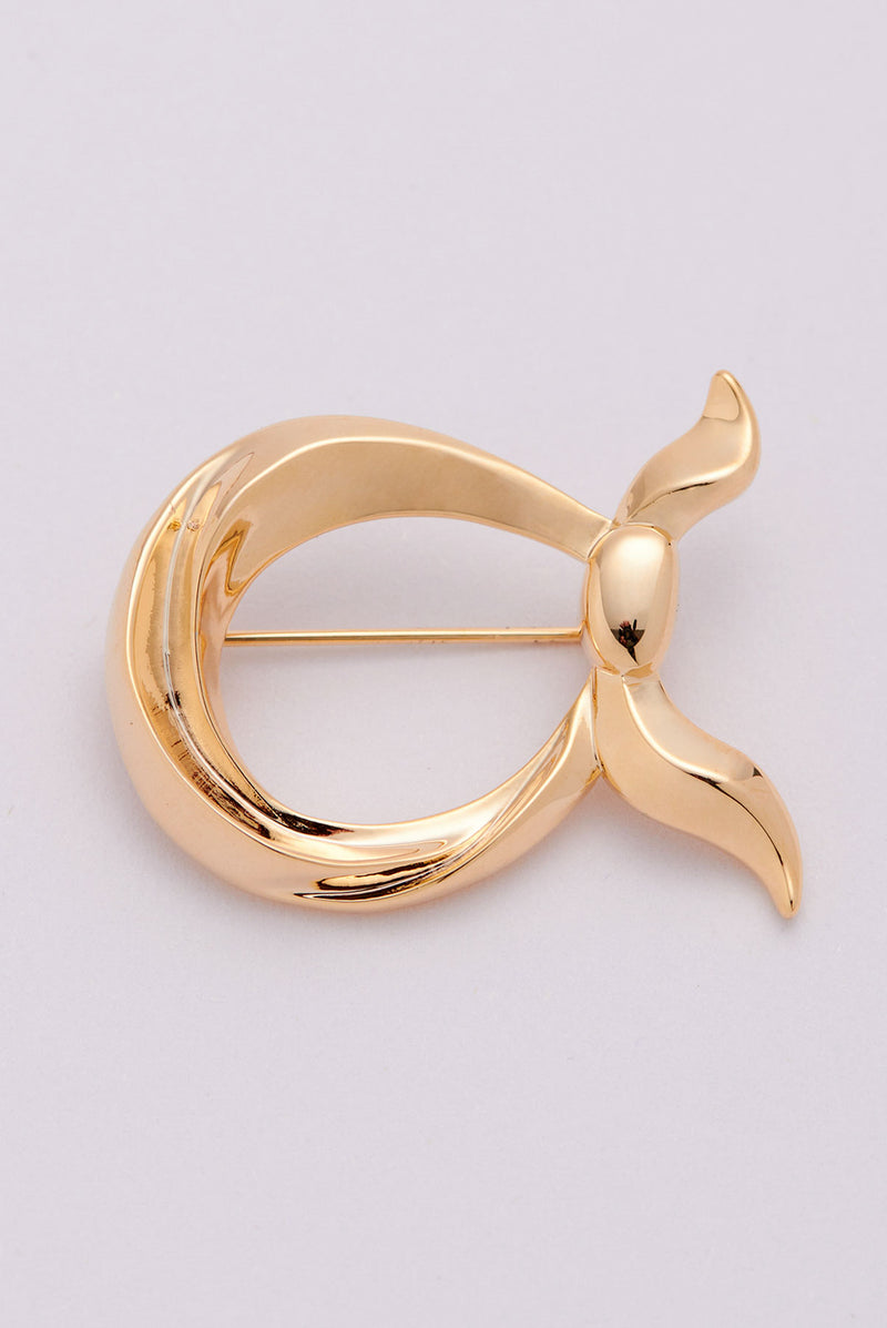 text -- gold brooch
