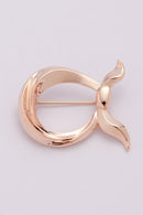 text -- rose gold brooch