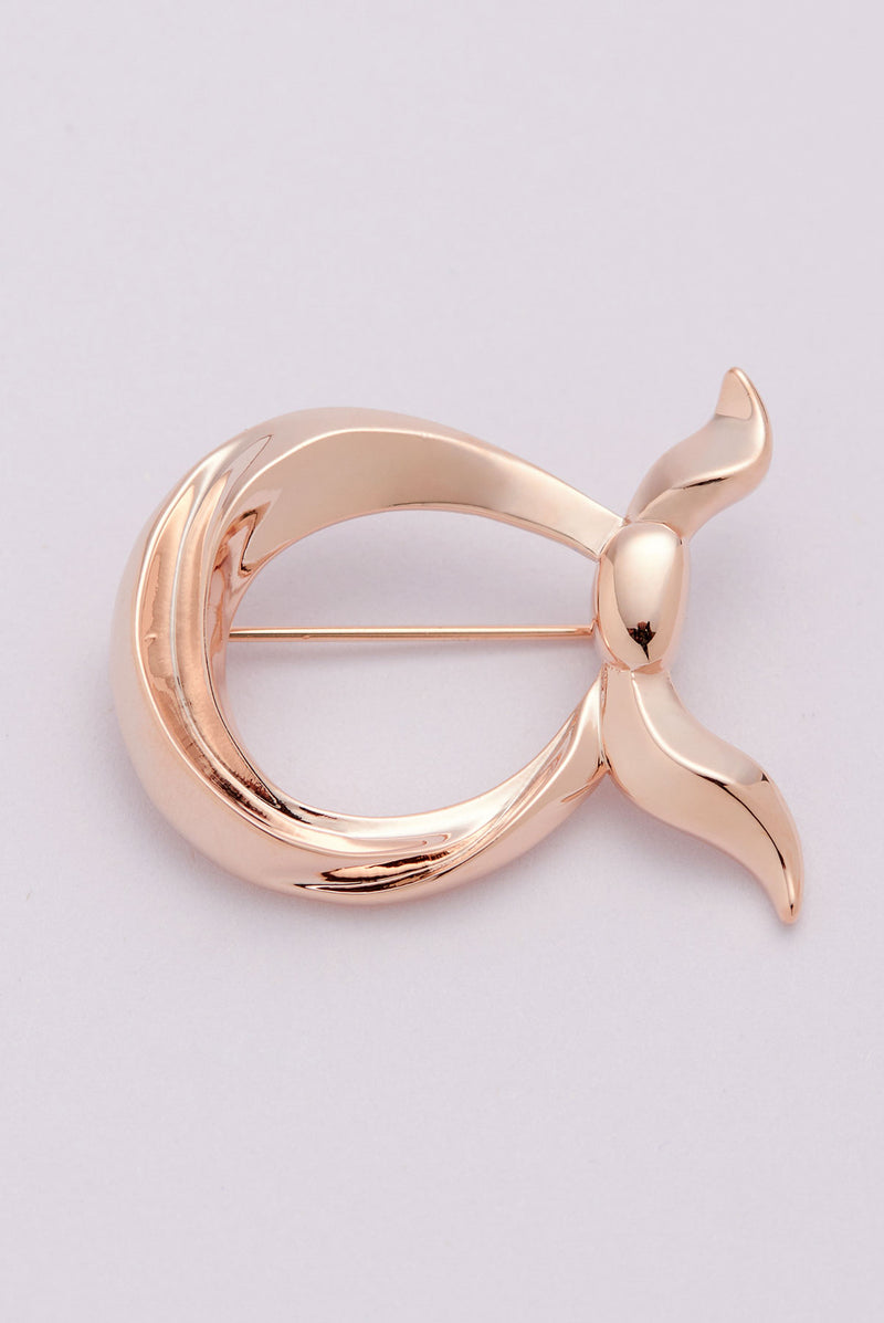 text -- rose gold brooch